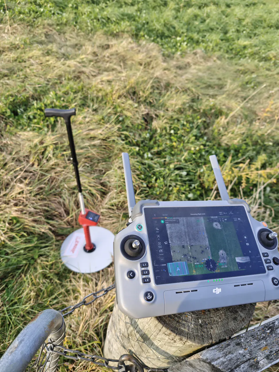 Drone controller and pasture measuring equipment beside a ground reference